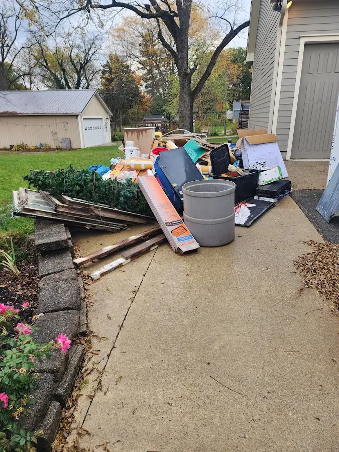 Dumpster being loaded with debris for Commercial Dumpster Rental in Hillcrest Heights